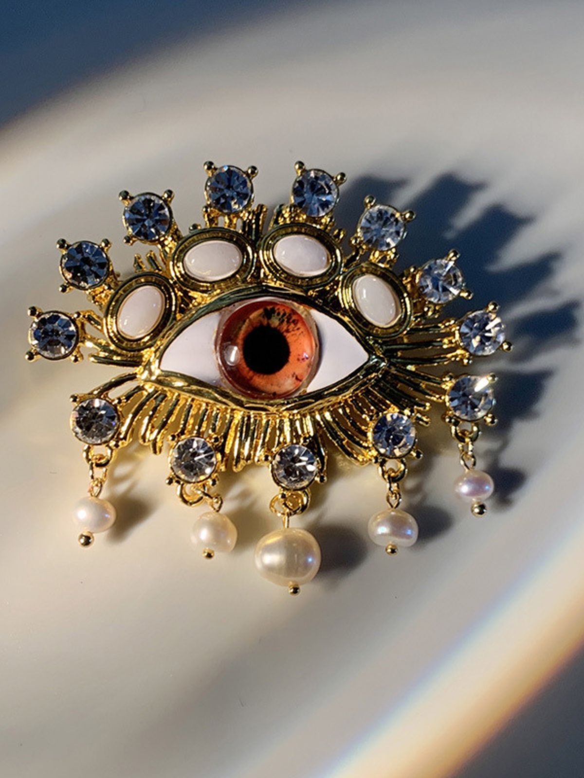 68a02c7834d6b762aaa7d4d8a64215dc.jpeg Fashionslee Women Pearl Embellihsed Eye Brooch